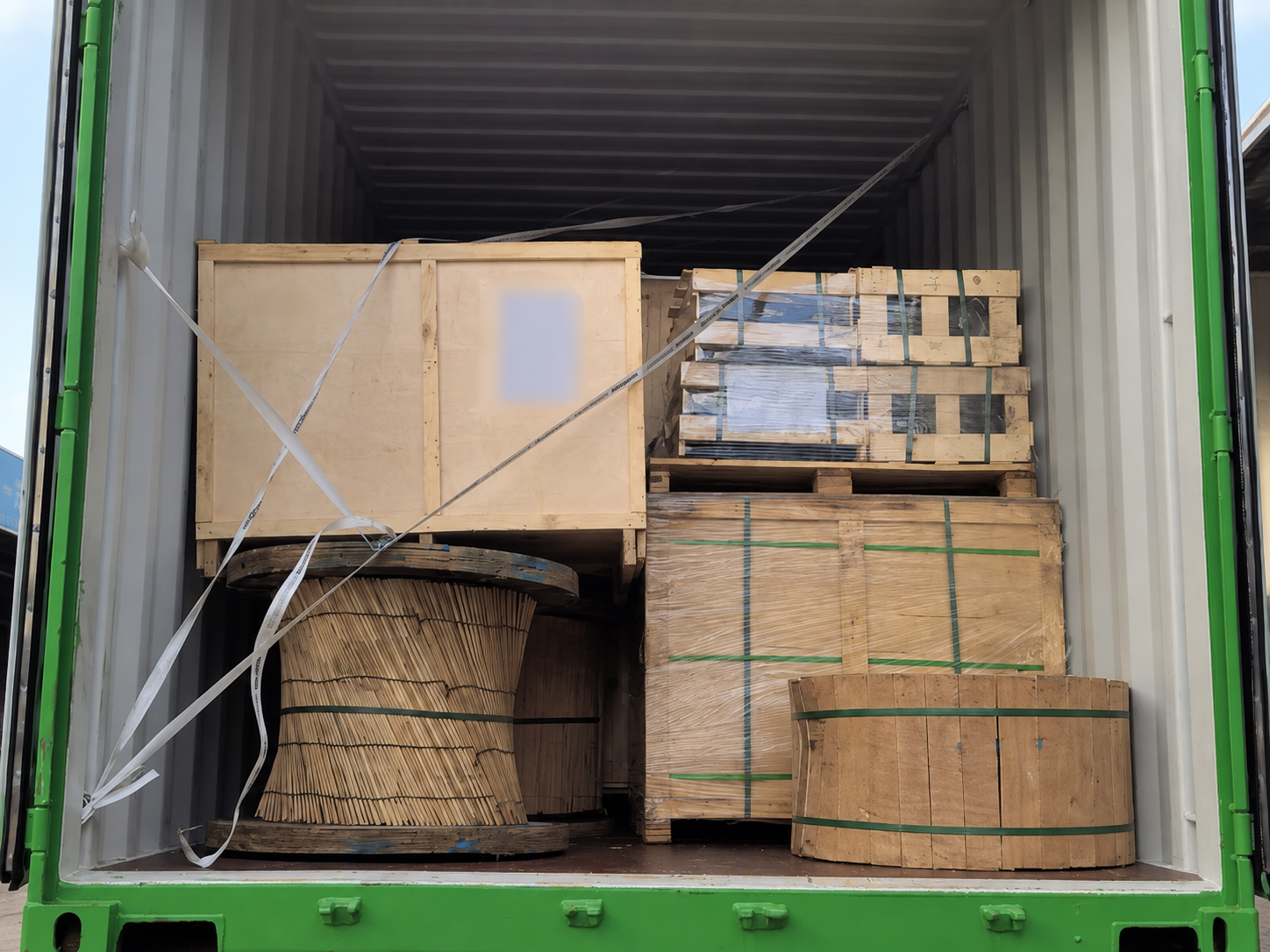 Export-packed 11kV overhead line materials during container loading for a Zambia project